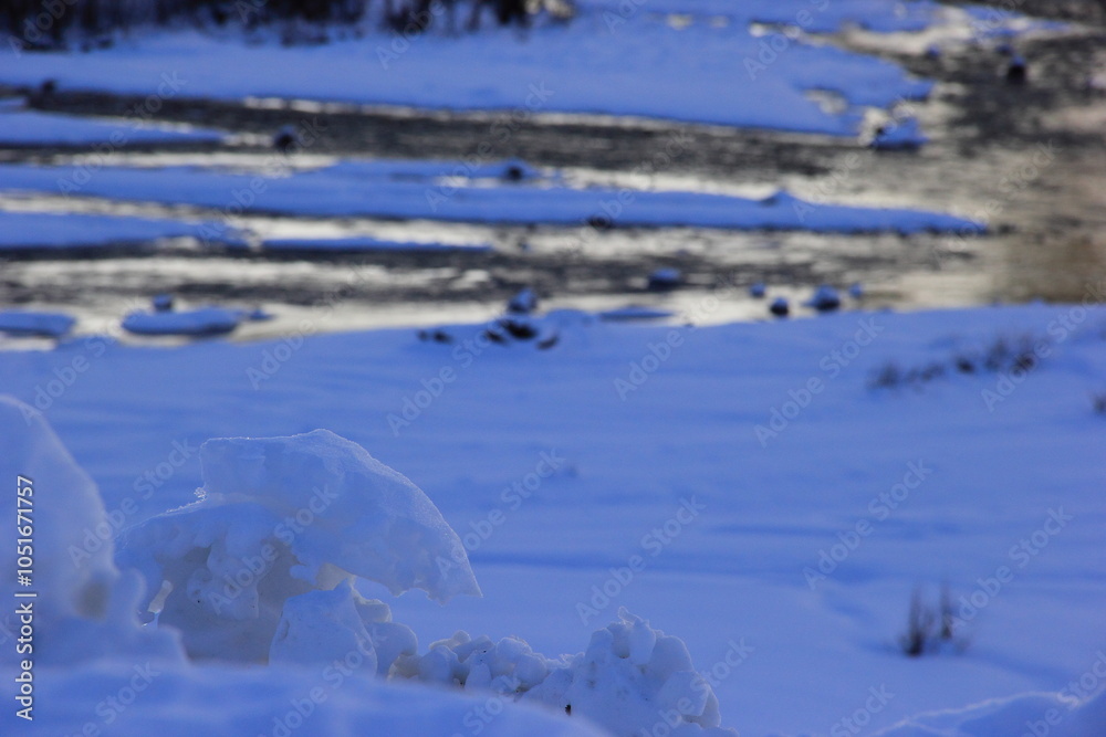 A hanging and melting snow icicle A hanging and melting snow icicle