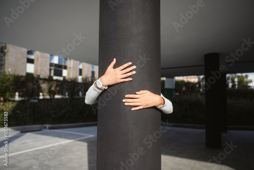 Girl hugging pillar at street photo