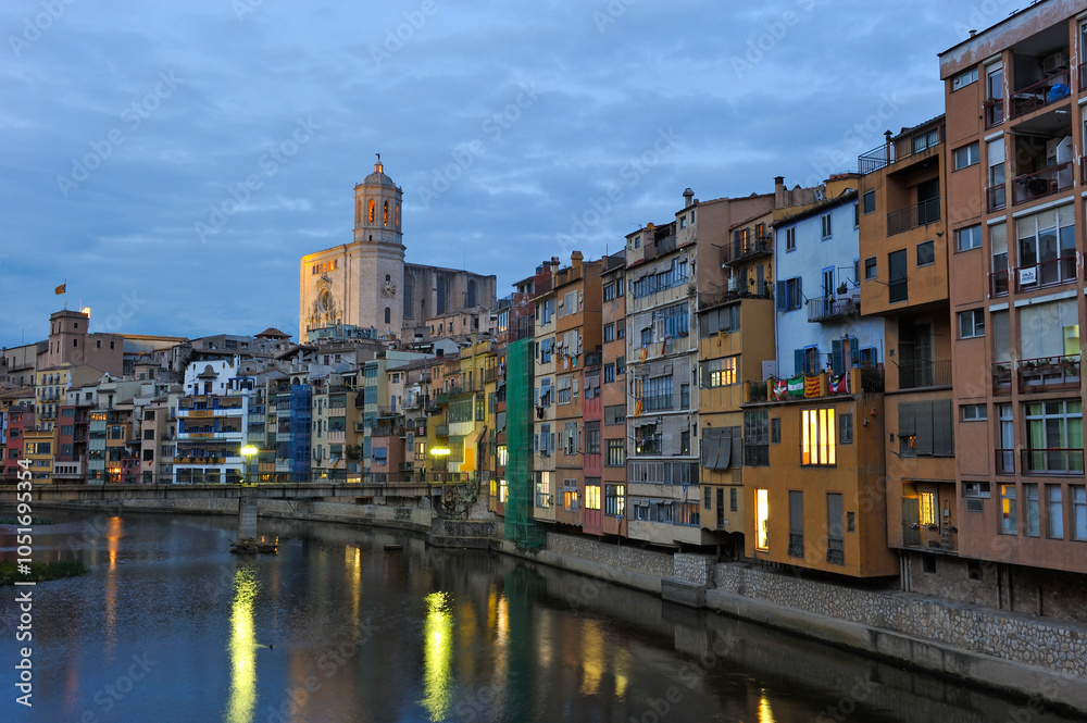 Front of the houses by the Onyar River at dusk, with the bell tower of the Cathedral in the background, Girona, Catalonia, Spain, Europe Front of the houses by the Onyar River at dusk, with the bell tower of the Cathedral in the background, Girona, Catalonia, Spain, Europe