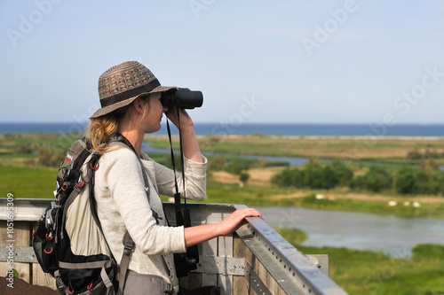 Young woman watching from Senillosa observation post in the Nature reserve of Els Aiguamolls de Emporda, Costa Brava, Catalonia, Spain, Europe photo