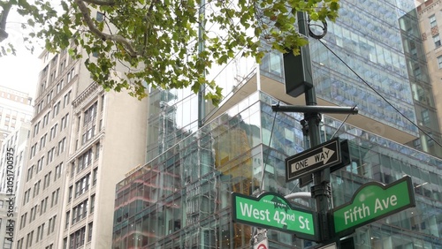 Fifth avenue, 5 ave road sign, Manhattan midtown highrise skyscraper architecture, New York City 5th av, 42 street corner near Bryant Park and Library. Traffic crossroad one way arrow signage, USA. photo