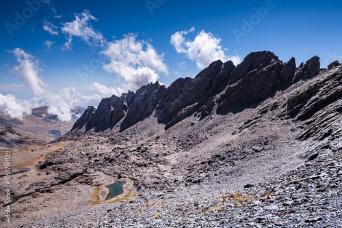 Dramatic rugged mountain range with a lake, Laguna del Rio Secco and Pico del Pulpito, Sierra Nevada, Andalusia, Spain, Europe photo