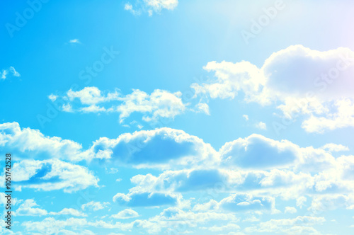 Sky background, blue cloudy sky with sunlight and cumulus clouds