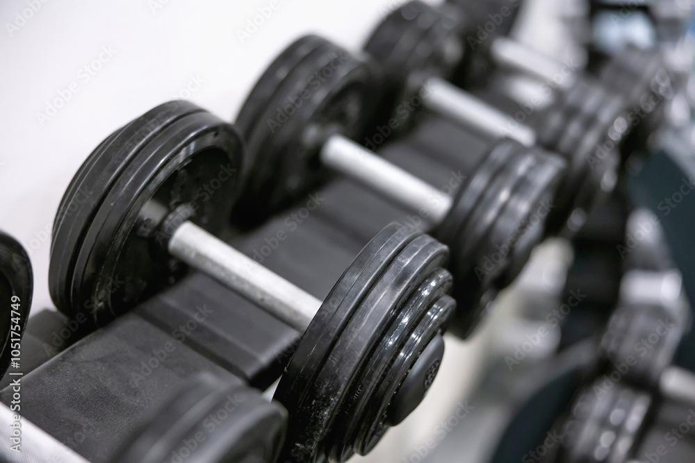 Row of heavy dumbbells in a modern fitness gym Row of heavy dumbbells in a modern fitness gym