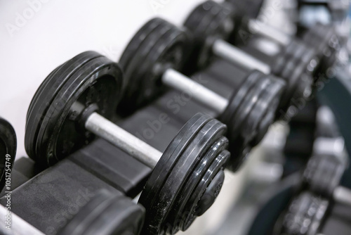 Row of heavy dumbbells in a modern fitness gym