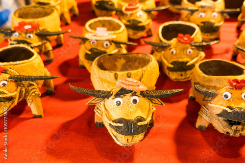 Nonthaburii, Thailand - September, 08, 2024 :Eco-Friendly Buffalo Crafts from Coconut Shells in Local Thai Market at Nonthaburii, Thailand. photo