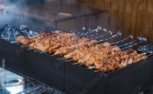 Close-up of meat skewers being grilled on a coal barbecue photo