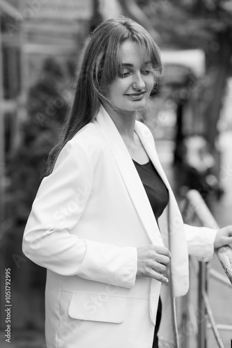 Elegant Young Woman Posing Outdoors in Stylish White Blazer