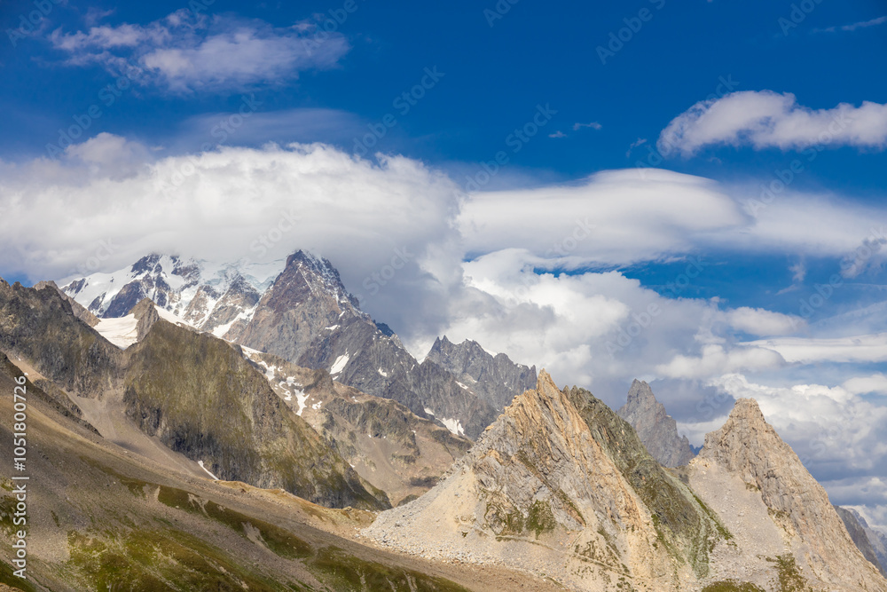 Naklejka premium Chamonix rocky granite mountain peaks in french Alps around Mont Blanc summit in Chamonix valley. Scenic landscape of iconic alpine summits the legends of mountaineering and alpinism
