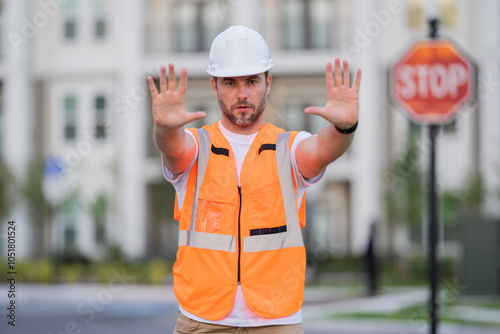 Construction worker with stop sign. stop sign or paddle used for traffic control by crossing guards, police or work zones. Construction area warning sign, stop hand safety