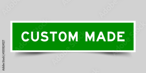 Green color square shape sticker label with word custom made on gray background