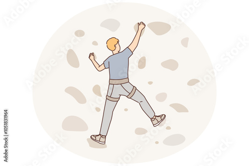 Man climbs on a climbing wall in a climbing gym isolated
