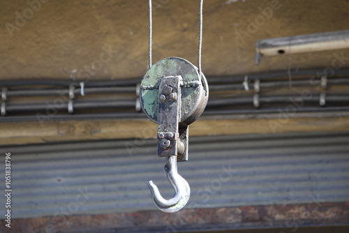 crane hook hangin over a car workshop photo