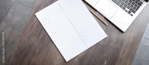 Office Desk with Blank Paper and Laptop on Wooden Table photo