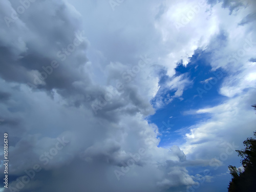Thick clouds cover the sky, leaving a small blue space that forms a pattern resembling a human face viewed in profile.