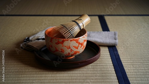 Traditional Japanese matcha tea ceremony set with whisk, bowl, and tray on tatami mat. photo