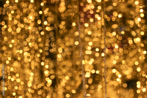 field of blur bokeh glowing golden light dots dust bulb with dark black background 