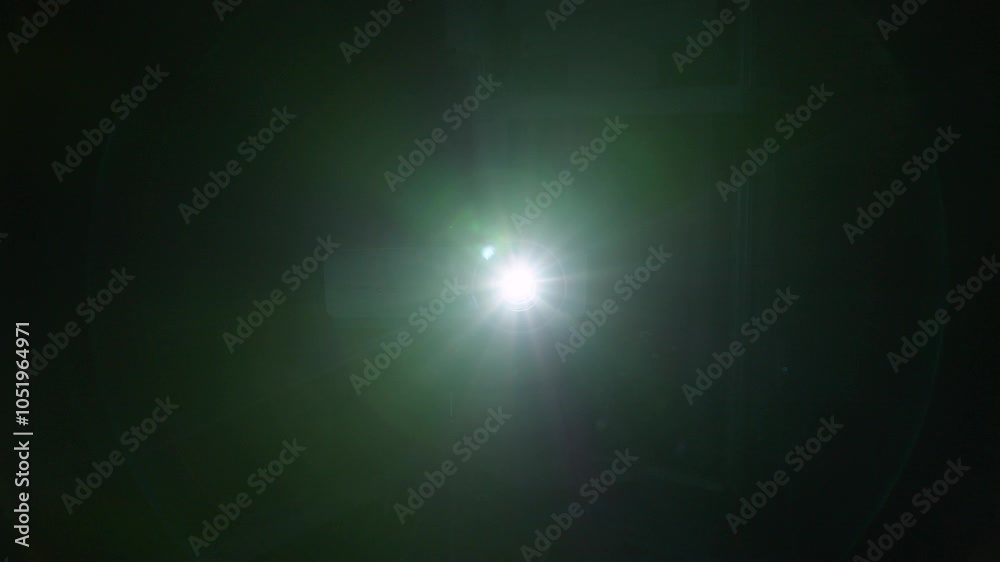 The video projector lights up and dazzles us with cold-coloured flashes of light