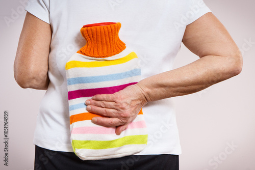 Canvas Print Senior woman with hot water bottle on her back