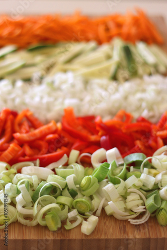 Obraz na płótnie Chopped leek, red pepper, onion, zucchini and carrot on the chopping board. Cooking and meal prepping at home. Selective focus. w salonie