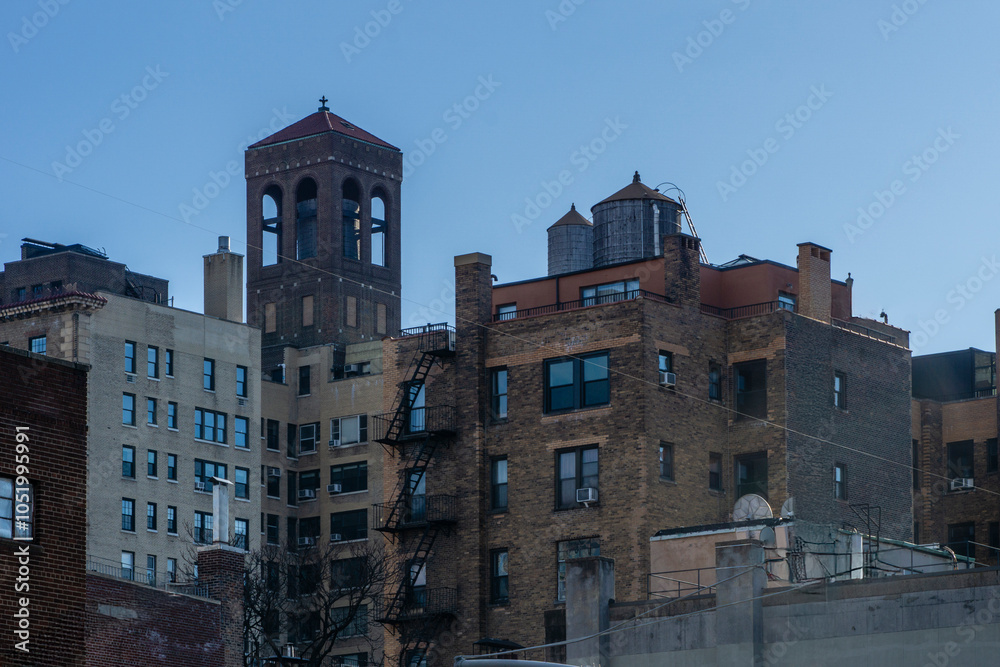 Fototapeta premium Low angle view of old brick buildings against sky in Midtown of Manhattan