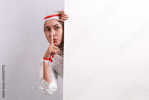 Close up photo of strict muslim lady with red white flag ribbon hide big billboard news text dont want share news charming gorgeous isolated white background photo