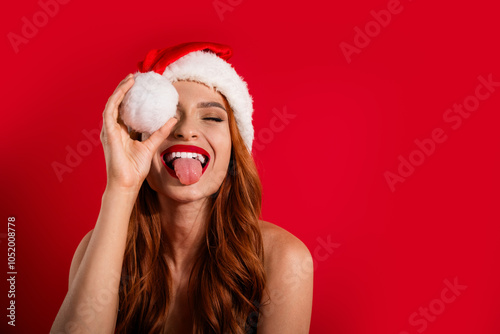 Photo of glad positive cheery charming girl celebrate xmas disco party empty space isolated on red color background photo