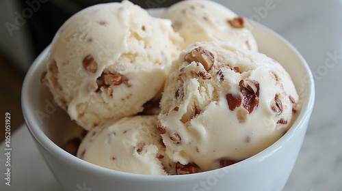 Vanilla ice cream with hazelnut on a bowl close-up