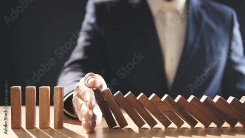Risk Assessment, Risk Management, Risk, Business, Economic, Financial Crisis. Businessman stop wooden block domino effect to safe, protect family, home from economic financial crisis, Insurance