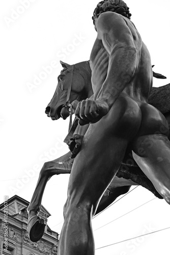 famouse horse sculpture against blue sky: The Horse Tamers, designed by the Russian sculptor, Baron Peter Klodt von Urgensburg. Anichkov bridge, Saint-Petersburg, Russia photo