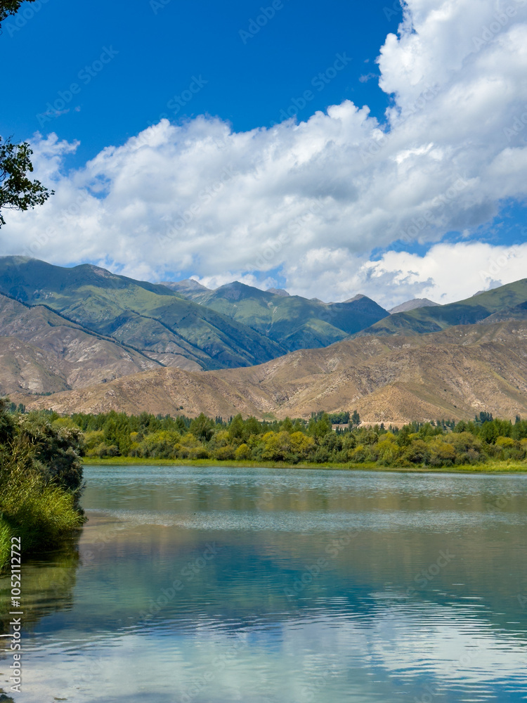 A wooden staircase leading into the clear waters of Issyk-Kul lake, with visible underwater vegetation. A perfect spot for water relaxation and enjoying nature A wooden staircase leading into the clear waters of Issyk-Kul lake, with visible underwater vegetation. A perfect spot for water relaxation and enjoying nature