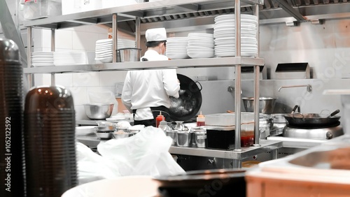 Fototapeta Naklejka Na Ścianę i Meble -  Restaurant Busy Kitchen, Chefs and Cooks Working on their Dishes