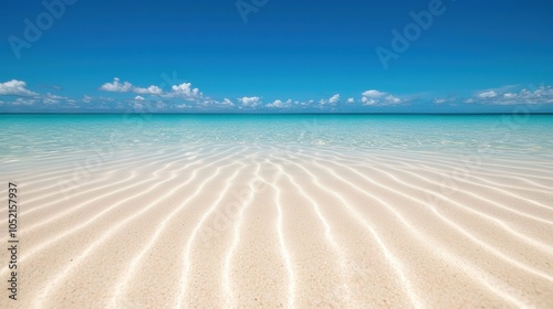 A serene beach scene with soft white sand and clear blue waters under a bright sky, creating a tranquil coastal atmosphere.