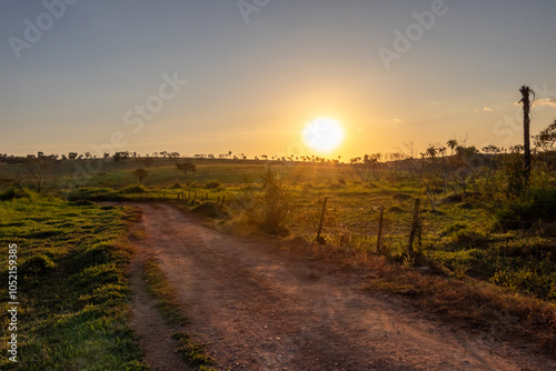 Fototapeta Naklejka Na Ścianę i Meble -  dirt road with sunset in the countryside