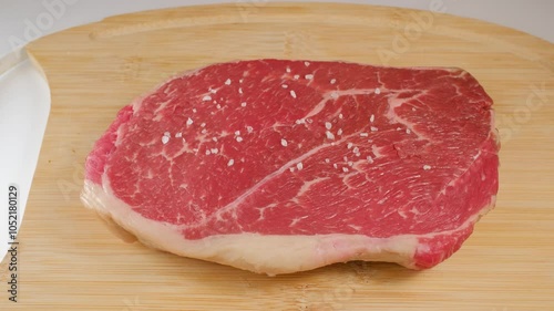 Preparing fresh beef meat with spices.