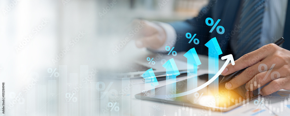 Fototapeta premium A businessman studies a digital chart with upward arrows and percentage symbols, representing financial growth, progress, and investment returns.
