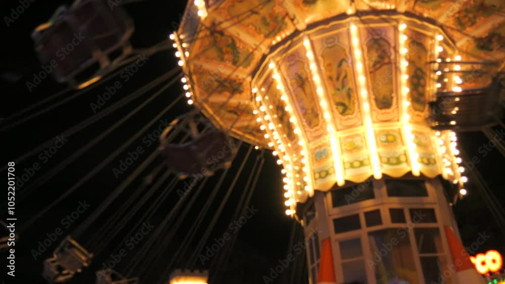 Carousel in an amusement park in slow motion at night. Holiday entertainment in the amusement park Carousel in an amusement park in slow motion at night. Holiday entertainment in the amusement park