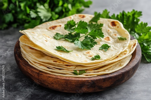 Chapati traditional tortillas with fresh parsley on a gray background indian flatbreads