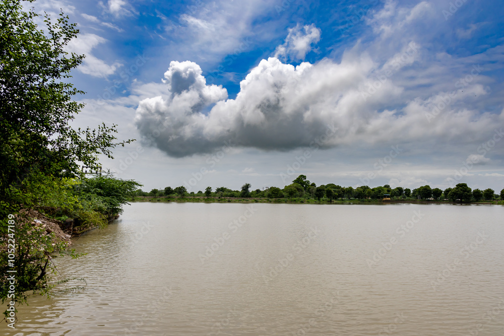 Flooded River Muddy Water with Bright blue Sky at morning Flooded River Muddy Water with Bright blue Sky at morning