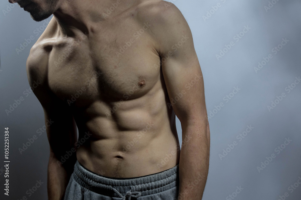 A young shirtless muscluar man A young shirtless muscluar man