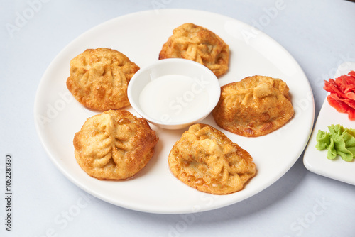 fried manty uzbek cuisine on wooden background top view