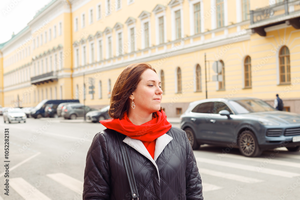 A woman thoughtfully with eyes closed on the street of a historic city. Tourism, walk A woman thoughtfully with eyes closed on the street of a historic city. Tourism, walk