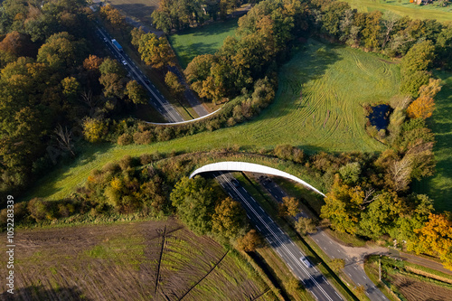 Motorway passing underneath Grimberg wildlife crossing forming a safe natural corridor bridge for animals to migrate between conservancy areas. Environment nature reserve infrastructure eco passage. photo