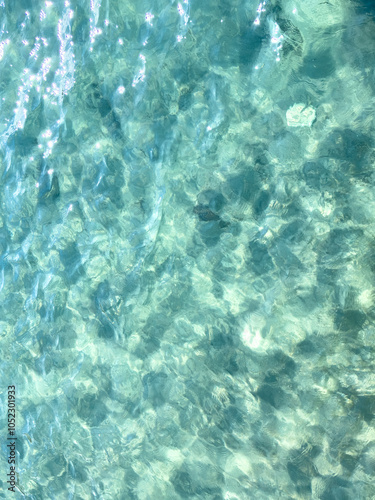 Texture of blue calm water creates a serene and peaceful background. The natural beauty of water reflects the essence of nature, evoking a sense of tranquility reminiscent of the sea.