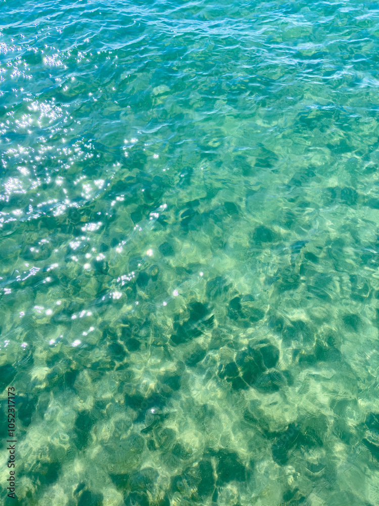 Fototapeta premium Texture of blue calm water creates a serene and peaceful background. The natural beauty of water reflects the essence of nature, evoking a sense of tranquility reminiscent of the sea.
