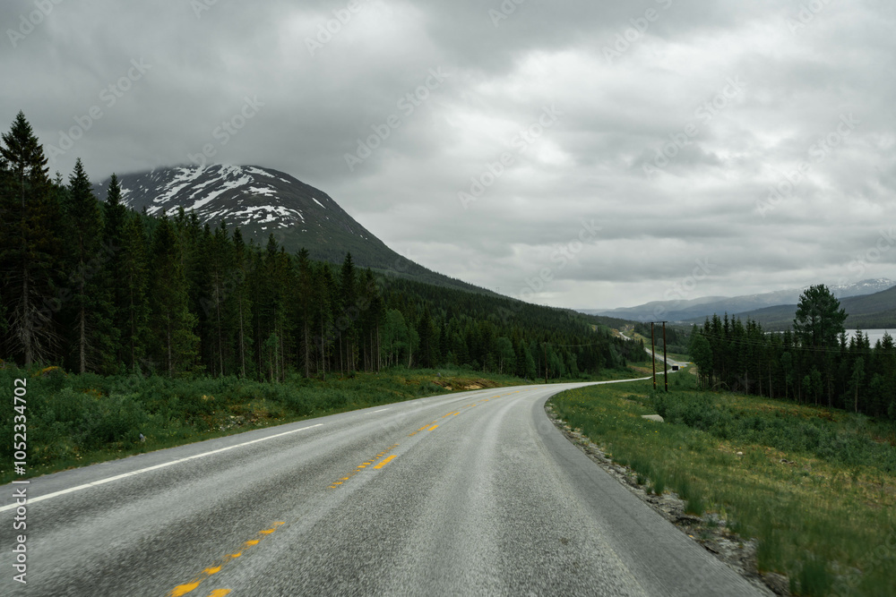 Empty road in a moody norway mountain landscape Empty road in a moody norway mountain landscape