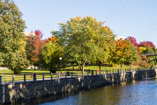 Rideau Canal in Ottawa, Canada during the autumn season, with vibrant fall foliage and a peaceful pathway