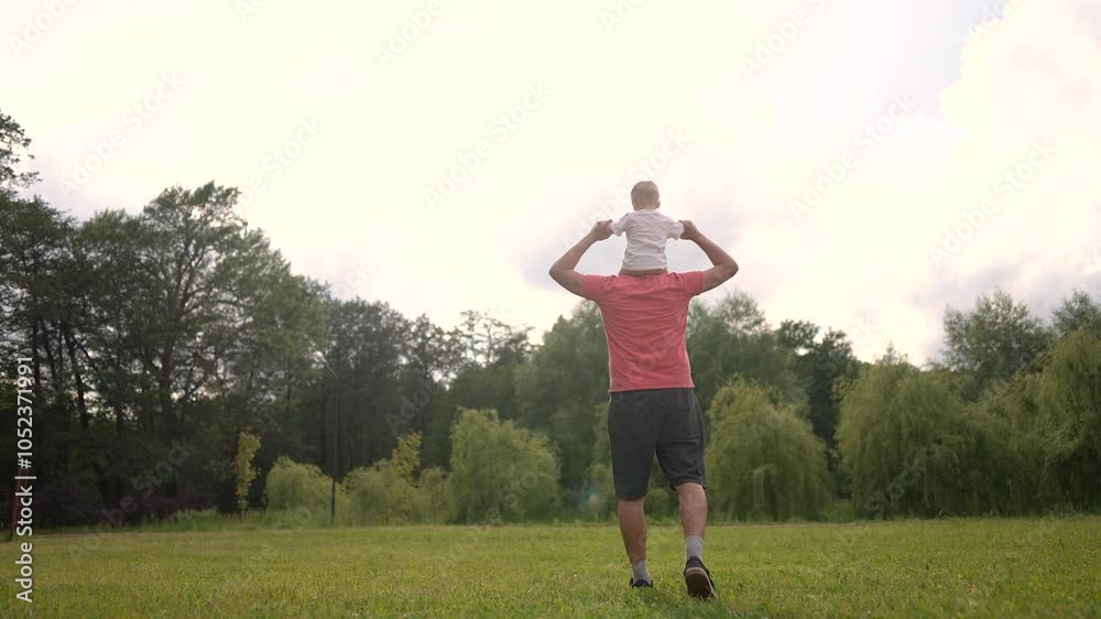 Father and son hugging on the neck on a sunny day. Family child happy concept. Father carries his son around the neck. Father carries his son around the neck on a sunny lifestyle day. Father and son hugging on the neck on a sunny day. Family child happy concept. Father carries his son around the neck. Father carries his son around the neck on a sunny lifestyle day.