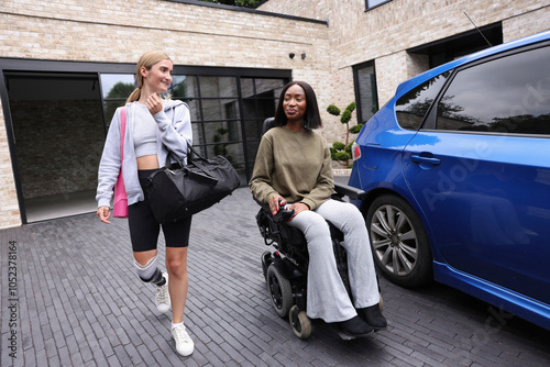 Smiling women leaving gym building together