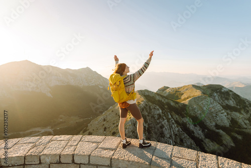 Happy  woman - tourist on the top of famous place. Negosh Mausoleum. Mountain Lovcen. Montenegro. photo